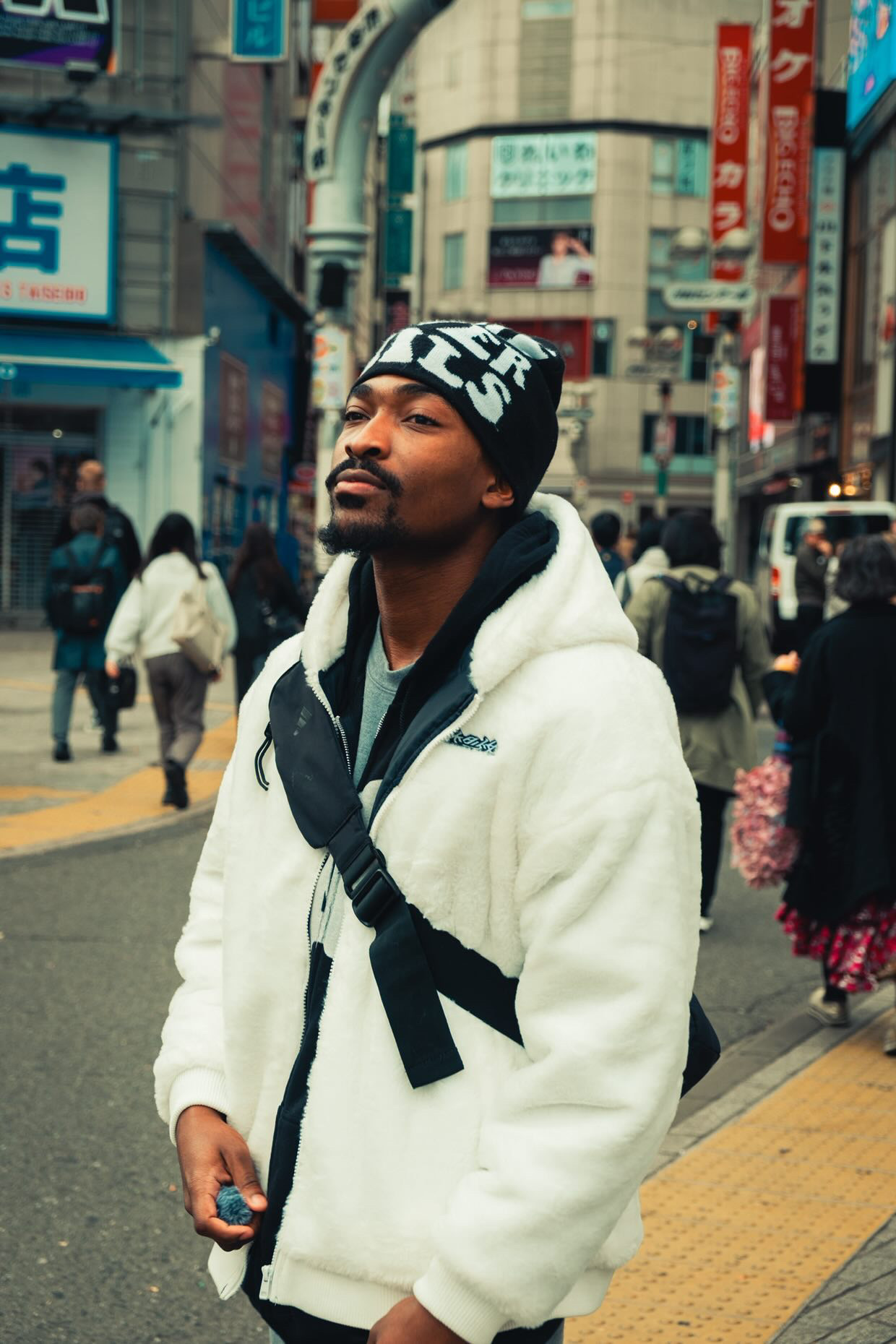 Chris Hovers in Shibuya wearing a WeCanGoFar beanie